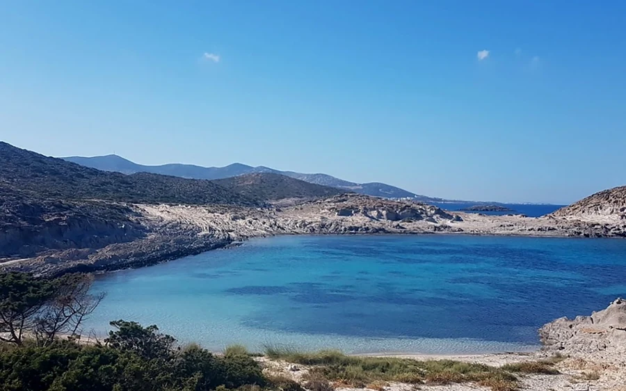 A turquoise bay ringed by low, rocky hills